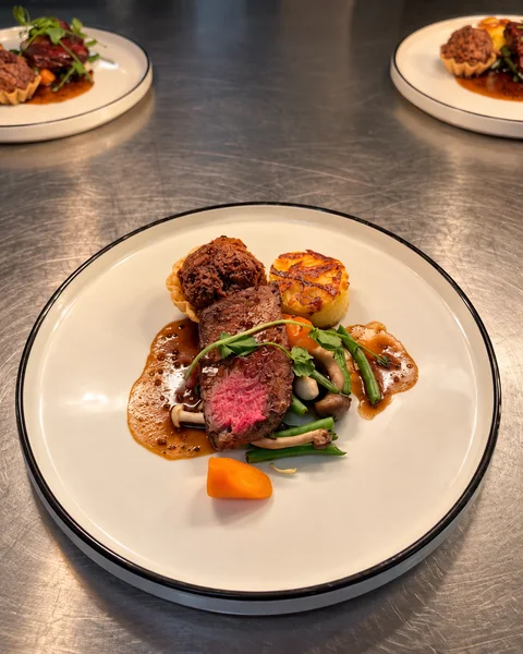 Plated beef with vegetables and sauce