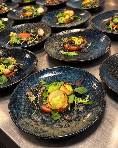 Individually plated dishes prepared for guests